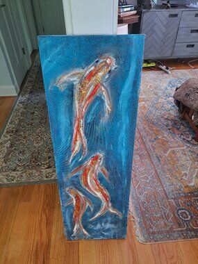 canvas painting featuring three koi fish swimming in textured blue waters, often